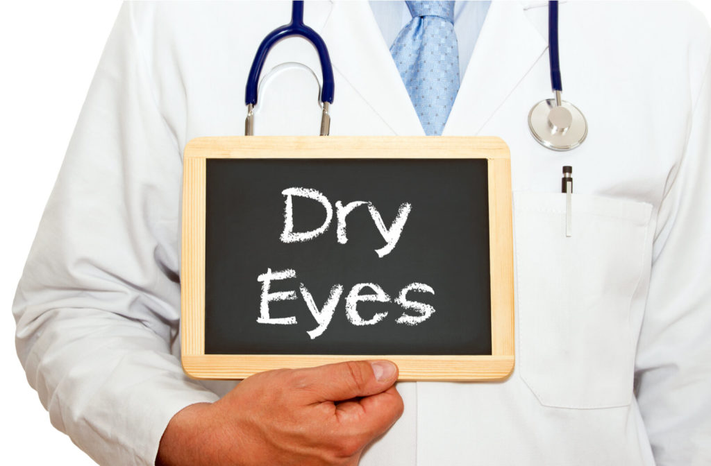 Doctor holding sign with the words "Dry Eyes" written on it